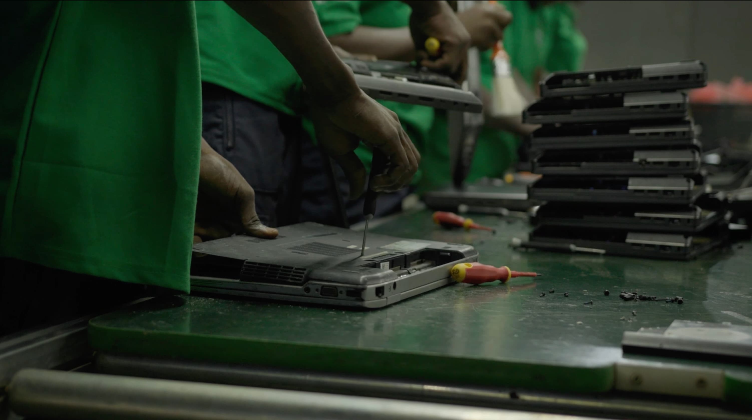 Close-up of a worker assembling a TV